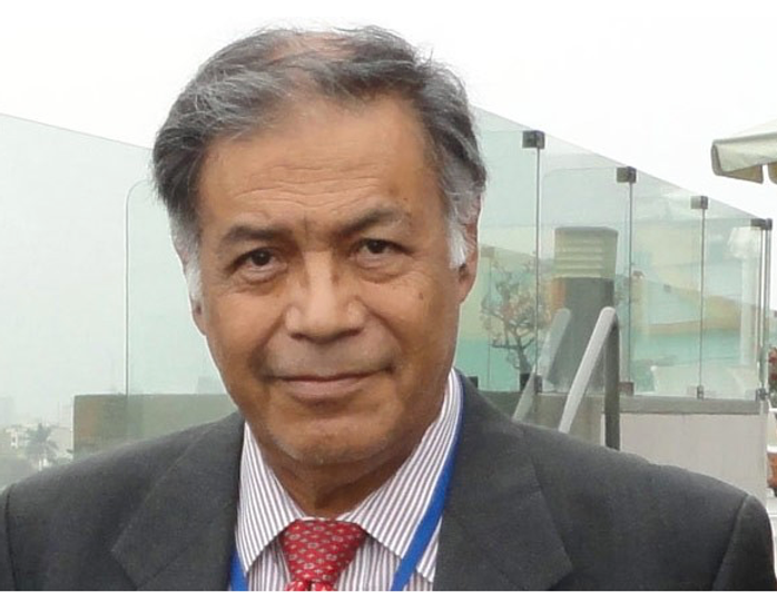 Dr Isaac Goiz in a suit with a red tie